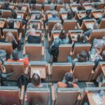 People sitting in chairs in a lecture hall or auditorium